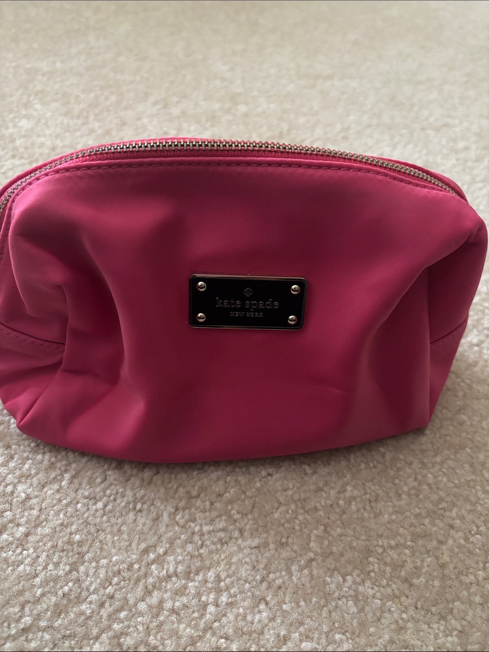 kate spade fuchsia cosmetic pouch with metal logo plaque